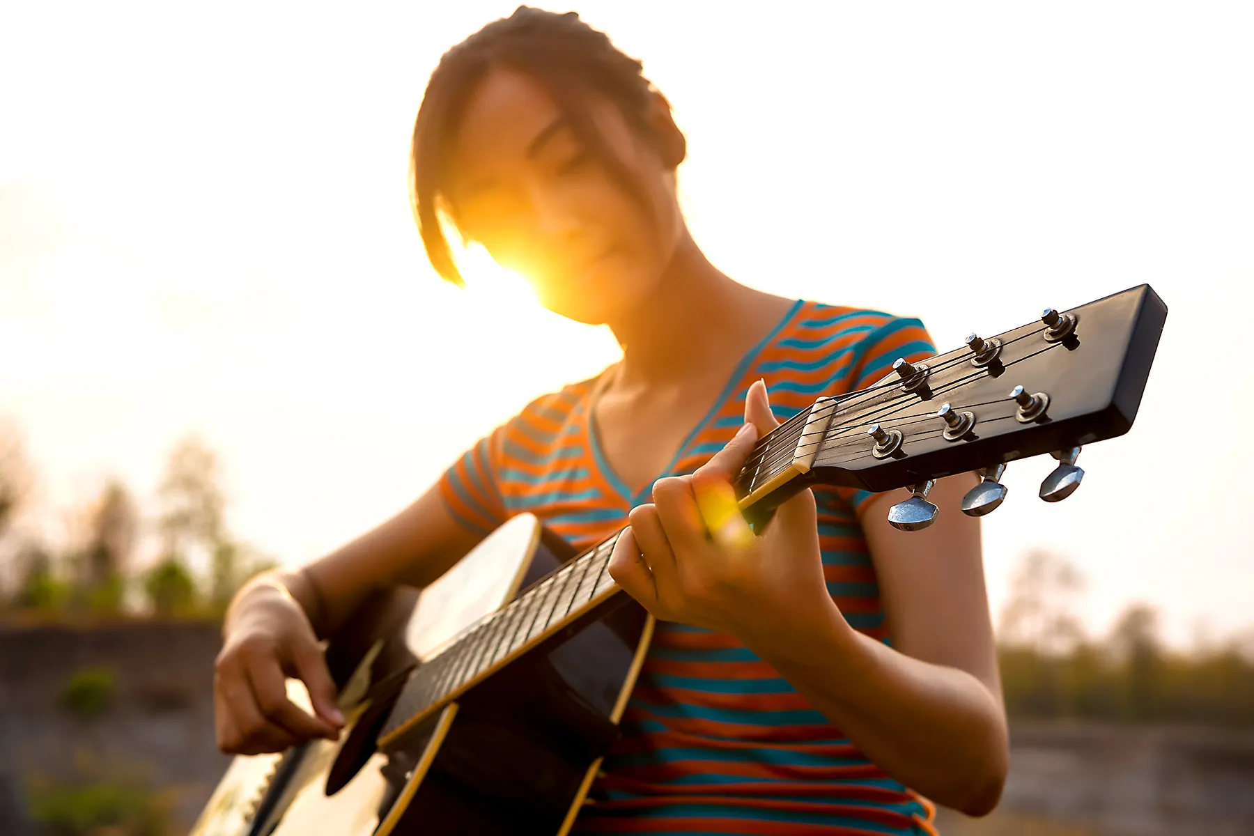 photo of person playing guitar