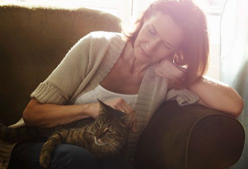 mature woman stroking cat