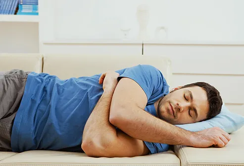 man napping on couch