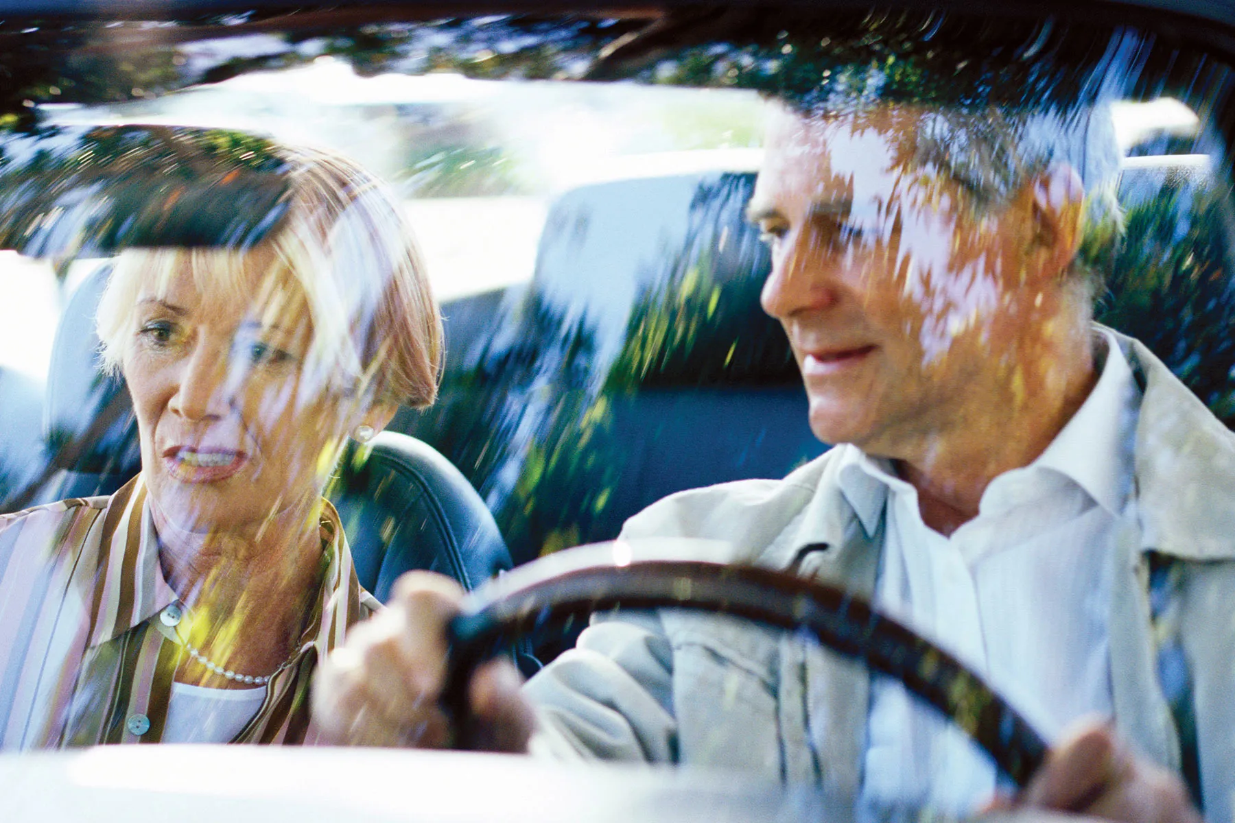 photo of couple driving in car