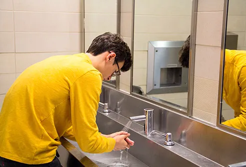 teen boy wash hands