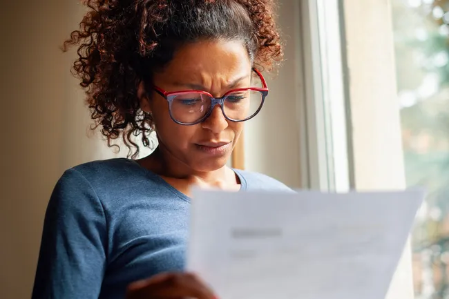photo of woman stressed over document