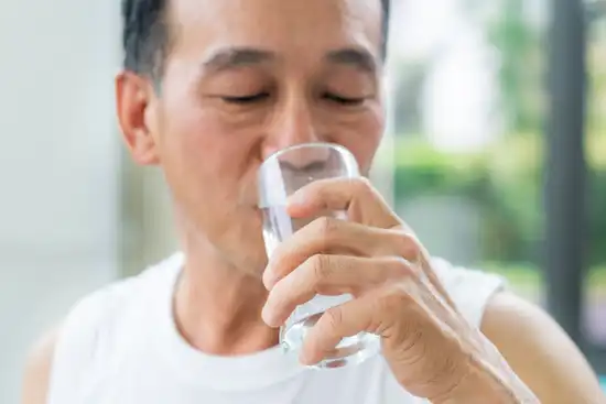 photo of mature man drinking water
