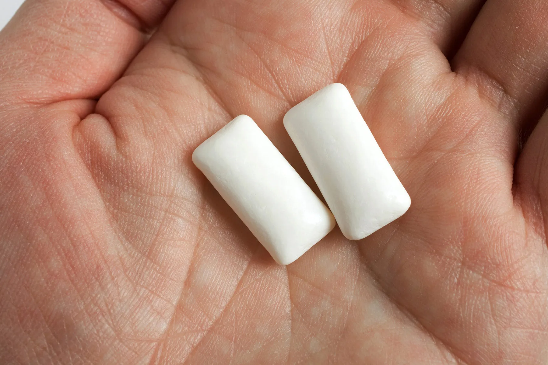 photo of pieces of chewing gum in hand