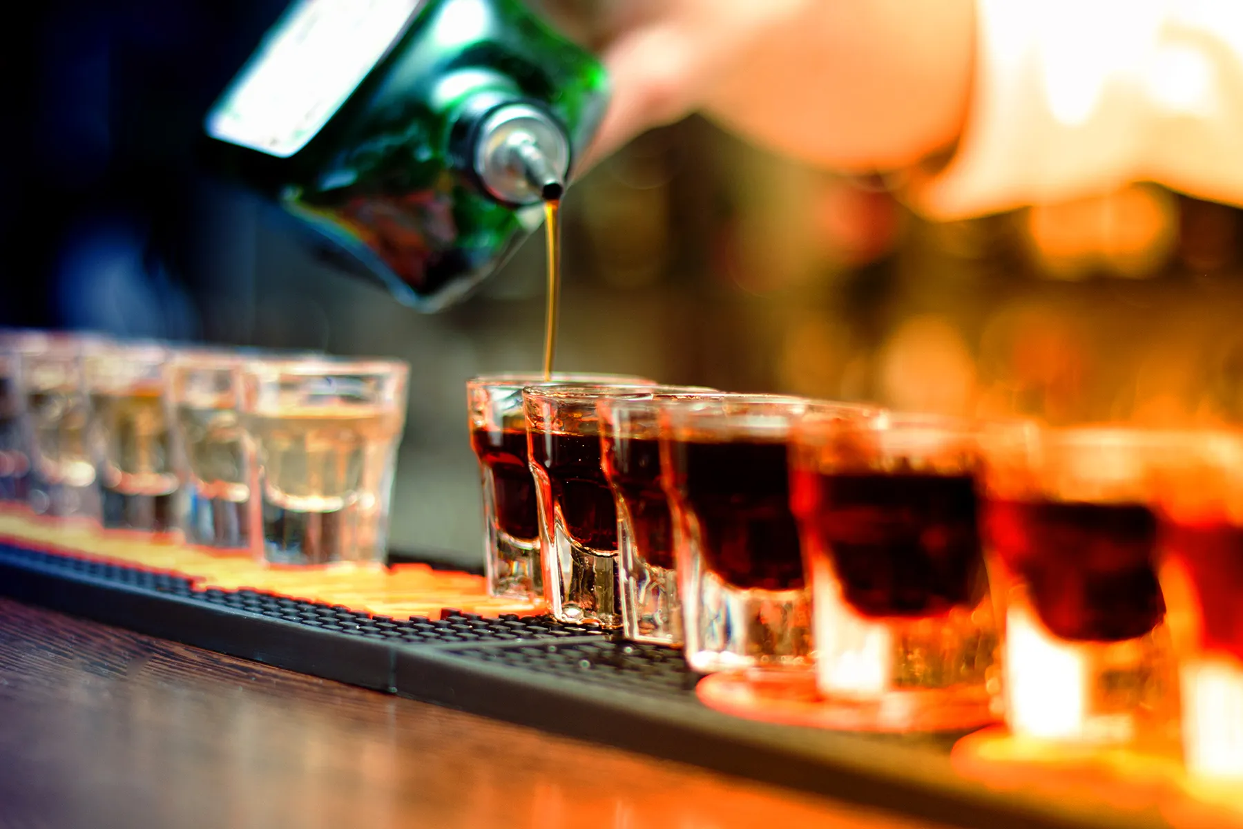 photo of shots of liquor on bar