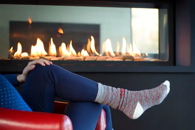 person sitting in front of fire place