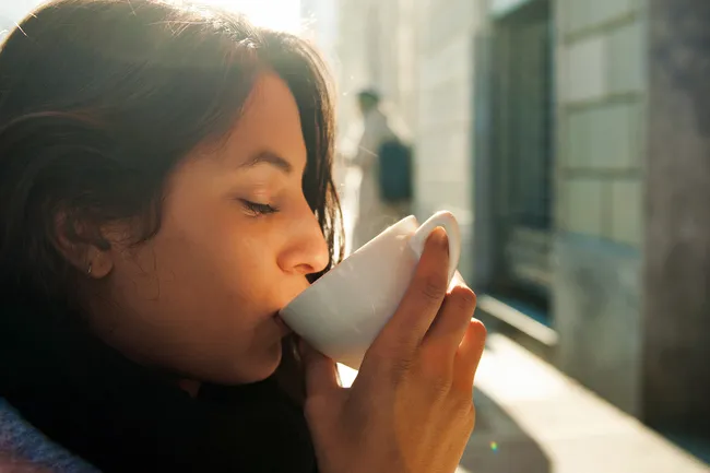 photo of person sipping coffee