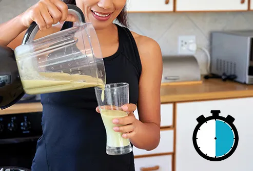 woman pouring smoothie with timer