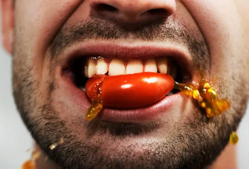 Man Eating a Tomato