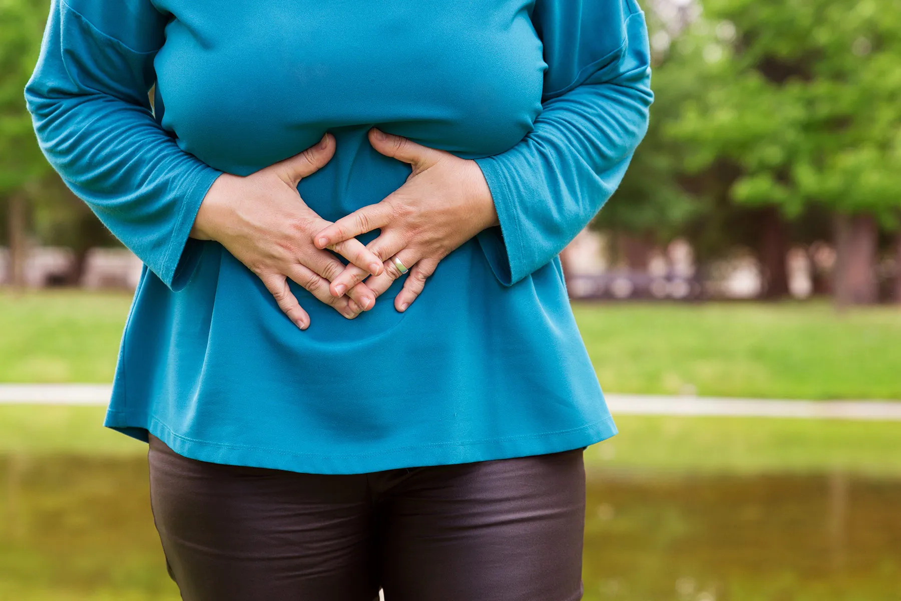 photo of woman holding her bloated stomach