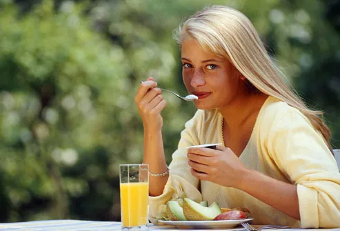 http://img.webmd.com/dtmcms/live/webmd/consumer_assets/site_images/articles/health_tools/skin_and_scalp_slideshow/photolibrary_rf_photo_of_young_woman_eating_breakfast.jpg