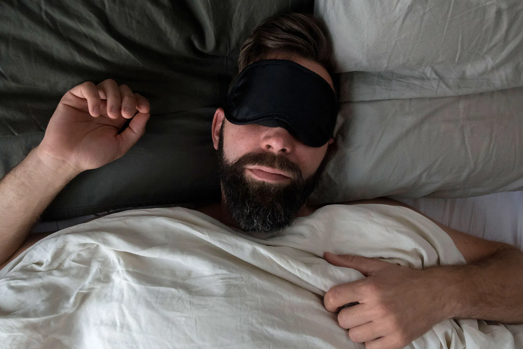 photo of man sleeping with eye mask