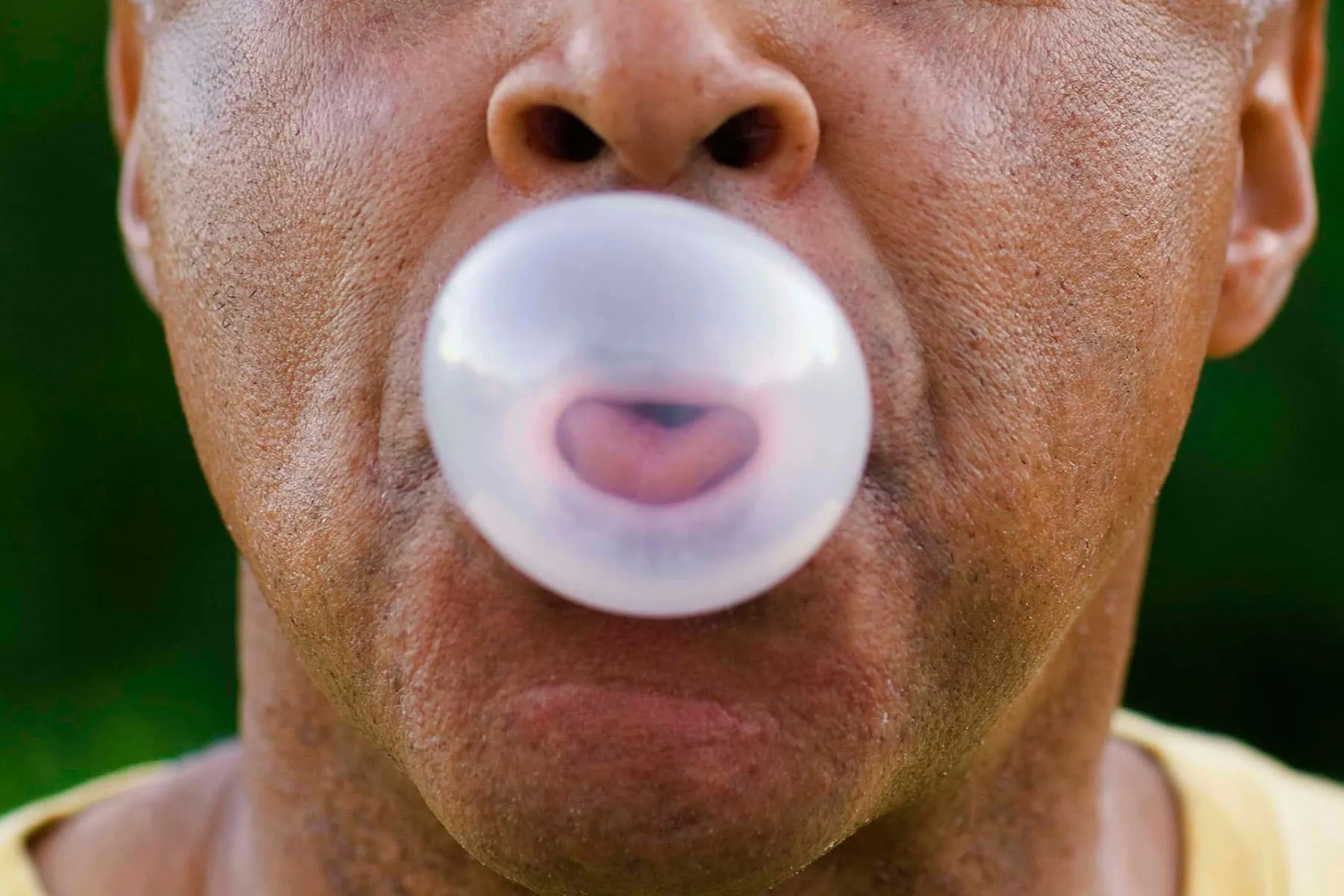 man blowing bubble gum