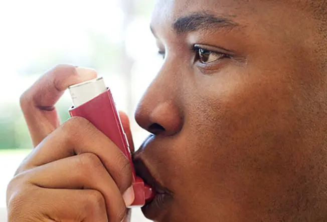 getty rf photo of man using inhaler