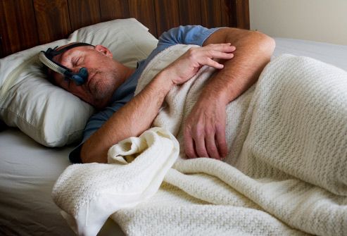 man sleeping with cpap machine