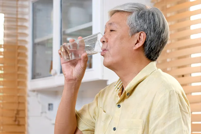photo of man drinking water
