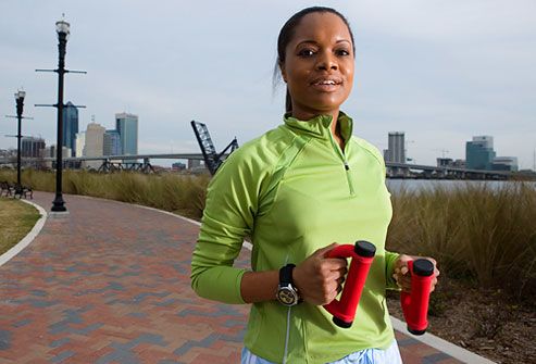 young woman in sports clothing  jogging on walkway