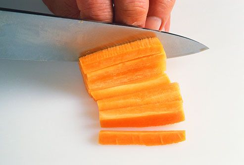 Person cutting a carrot