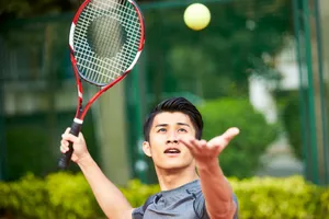 photo of man playing tennis