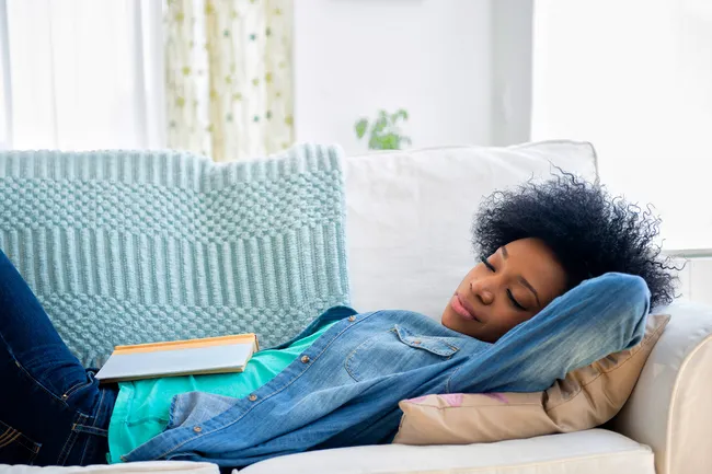 photo of woman napping on sofa