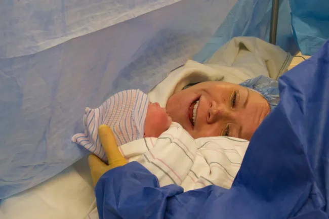 photo of woman with new baby after c section
