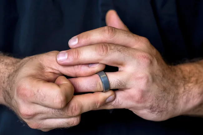 photo of man fidgeting with ring close up