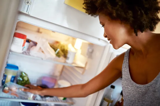 photo of woman looking in refrigerator