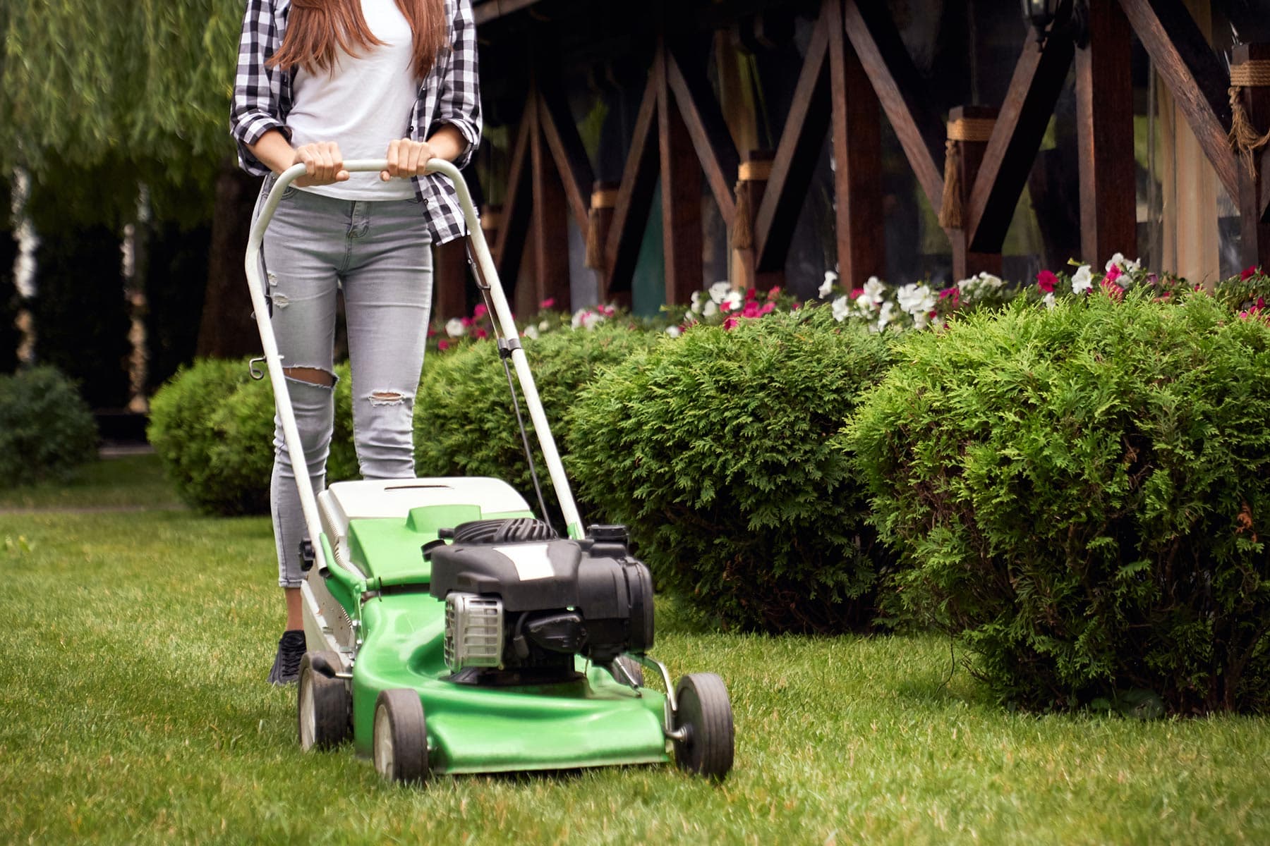 photo of woman cutting lawn