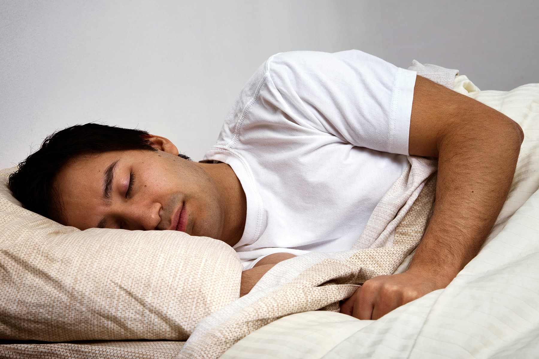 photo of man sleeping in bed