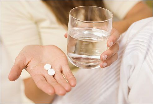 Woman With Pill and Water