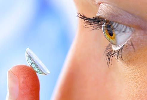 woman applying contact lense