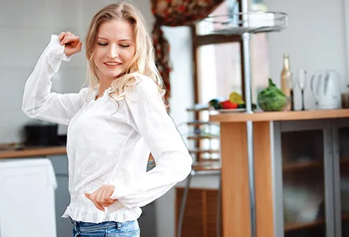 woman dancing at home alone