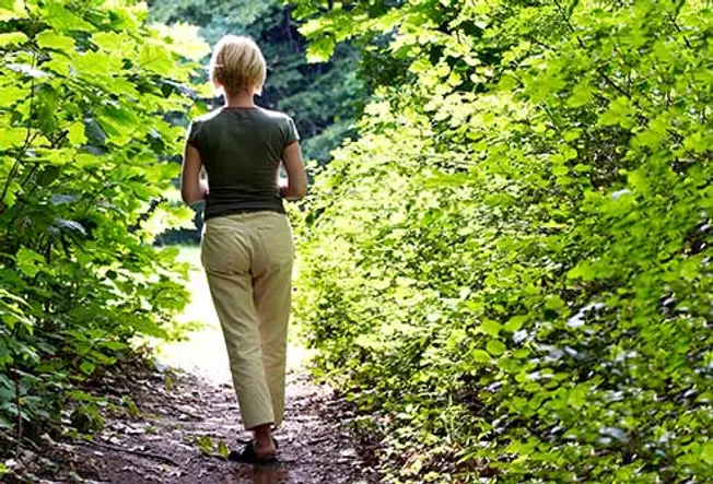 woman walking alone in the woods