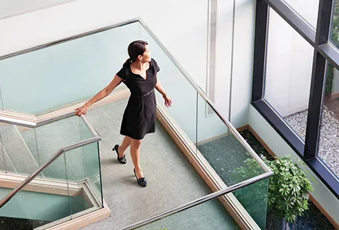 woman walking down office stairs