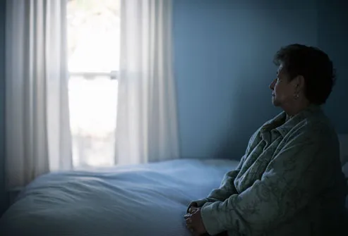 Depressed Woman Sitting on Bed