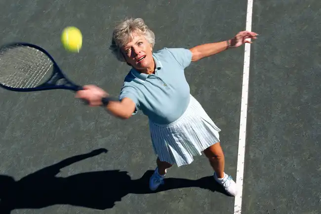 senior woman playing tennis