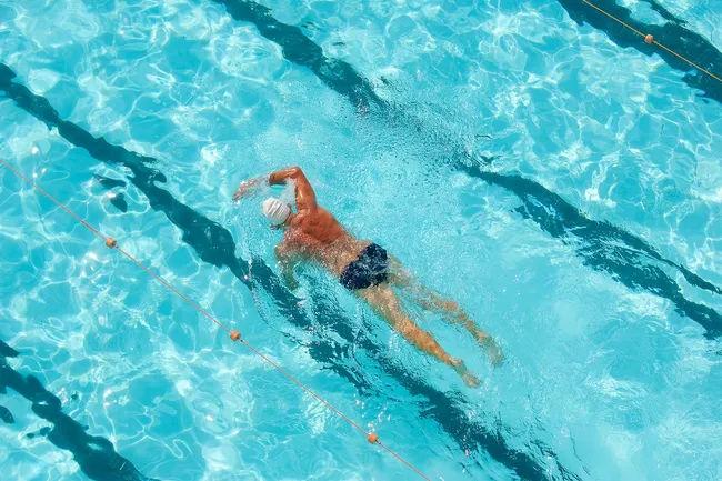 photo of mature man swimming