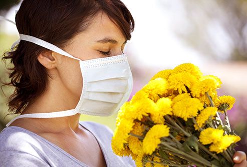 http://img.webmd.com/dtmcms/live/webmd/consumer_assets/site_images/articles/health_tools/ways_to_reduce_mold_allergies_slideshow/getty_rf_photo_of_allergic_woman_smelling_flowers.jpg