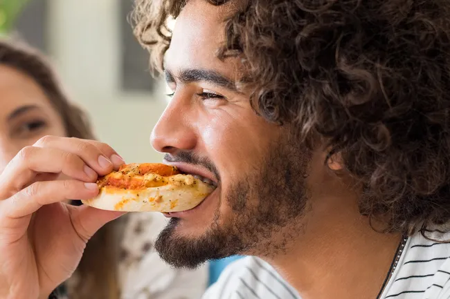 man eating pizza