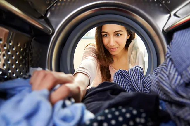 woman removing clothes from dryer
