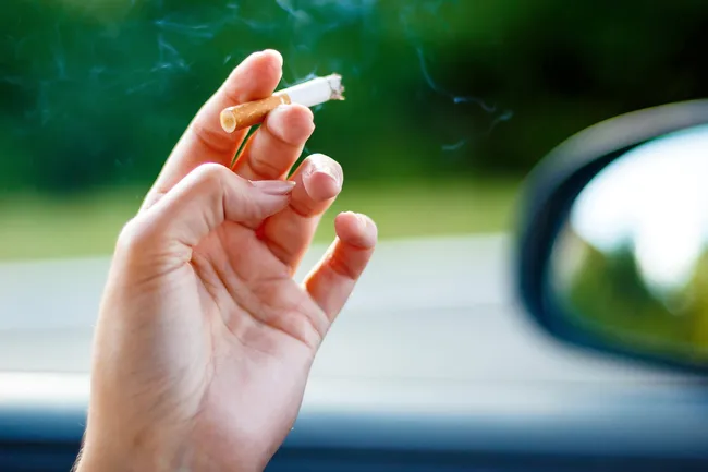 photo of smoking cigarette in car