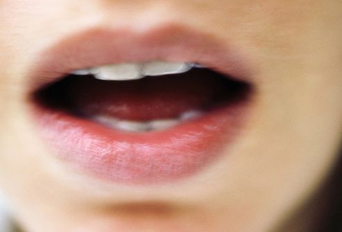 close up of womans open mouth