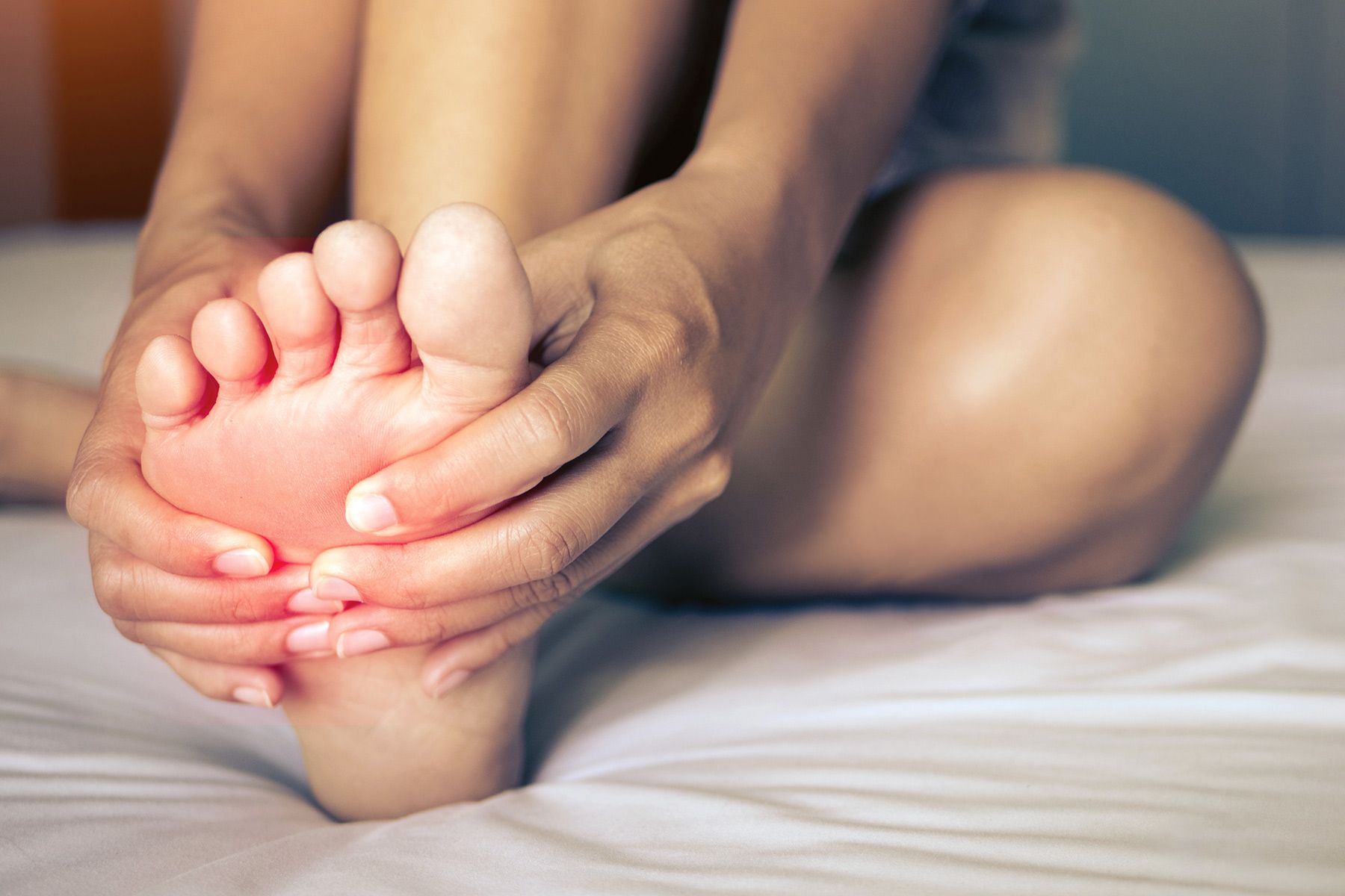 woman massaging foot close up