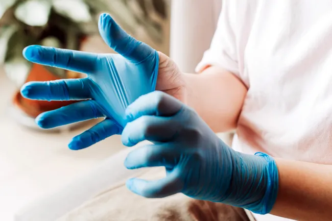 photo of putting on latex gloves