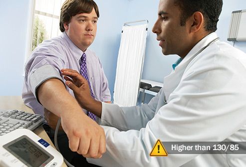 doctor checking mans blood pressure