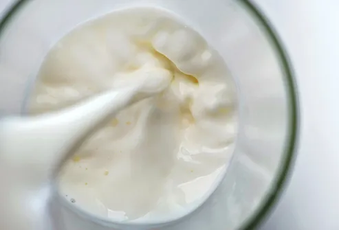 pouring glass of milk close up