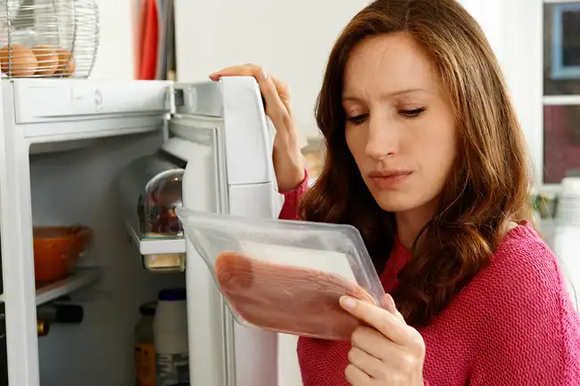 woman looking at lunch meat