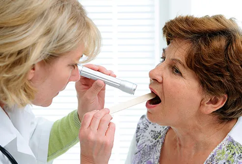 doctor examining patient mouth