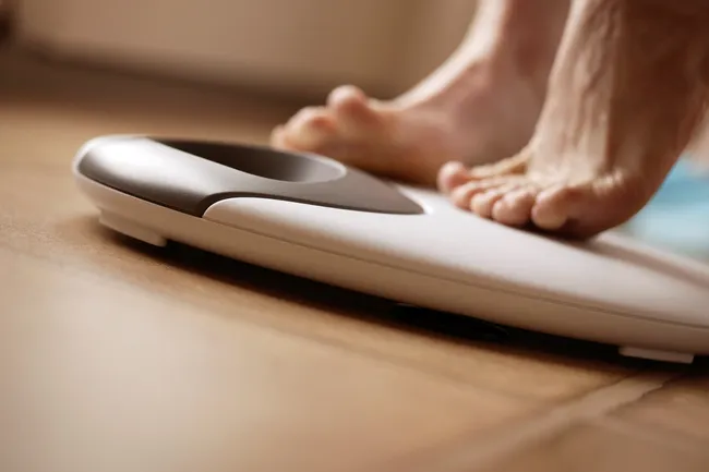 photo of woman's feet on weight scale