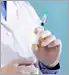 doctor holding syringe